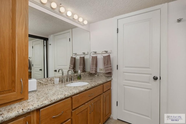 bathroom featuring vanity and a textured ceiling