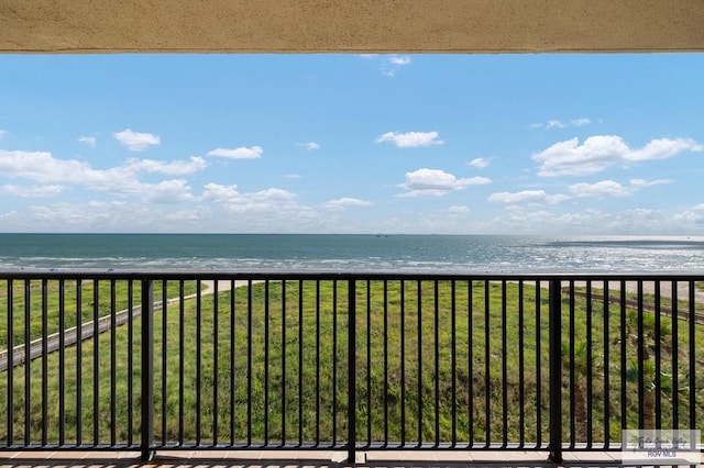 balcony with a beach view and a water view