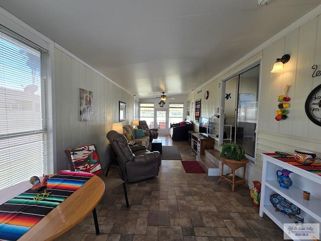 sunroom / solarium featuring ceiling fan