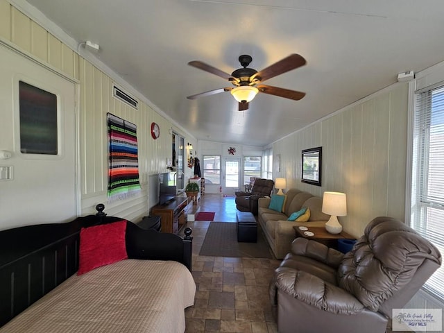 living room featuring crown molding and ceiling fan