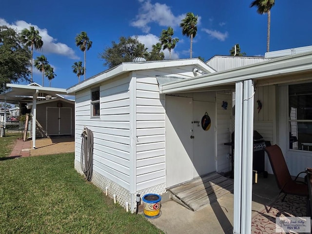 entrance to property with a yard