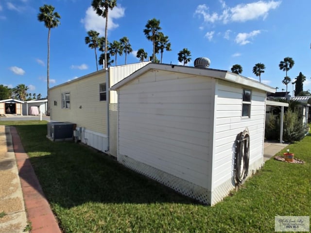 view of home's exterior with a lawn and central air condition unit