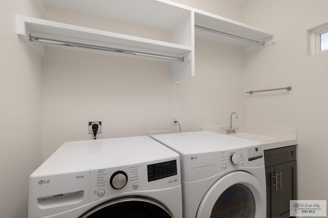laundry area with a sink, cabinet space, and washer and dryer