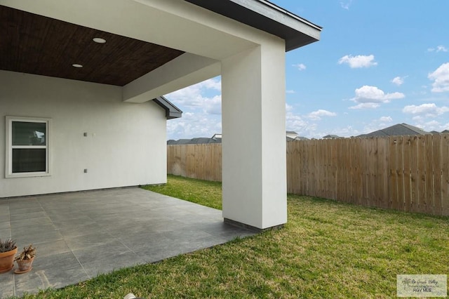 view of yard with a fenced backyard and a patio