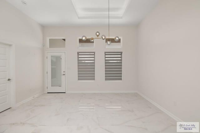 empty room with baseboards and marble finish floor