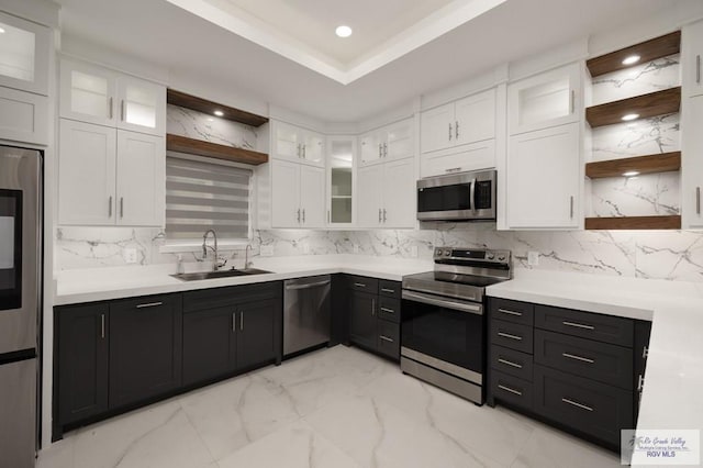 kitchen featuring open shelves, marble finish floor, white cabinets, a sink, and stainless steel appliances