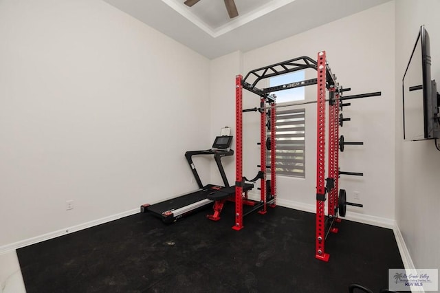 exercise area featuring baseboards and ceiling fan