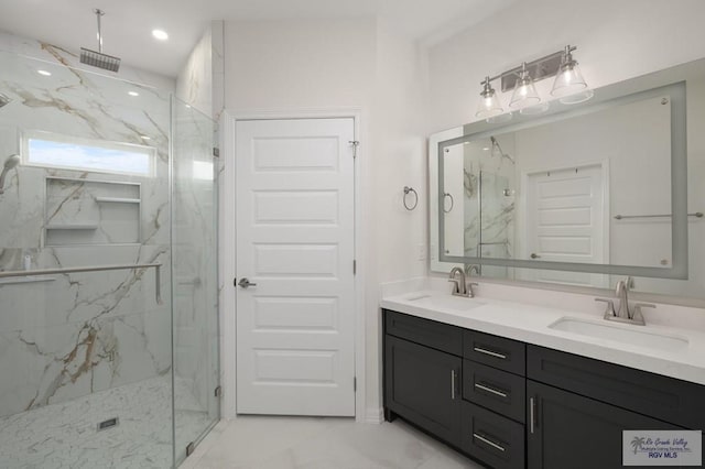 bathroom featuring a sink, a marble finish shower, and marble finish floor