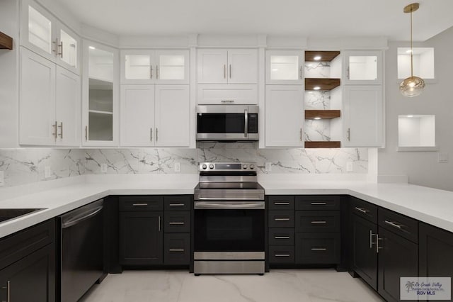 kitchen with white cabinets, stainless steel appliances, open shelves, and light countertops