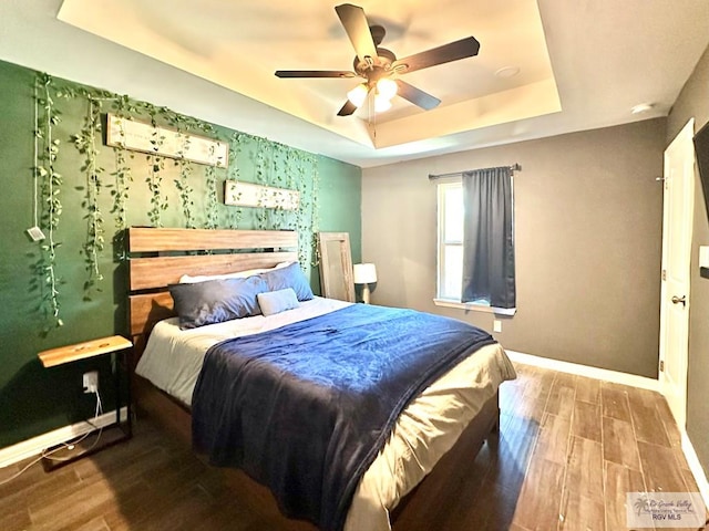 2901 Tree Top Ct, Harlingen, TX 78552 - bedroom with a raised ceiling, wood finished floors, baseboards, and ceiling fan