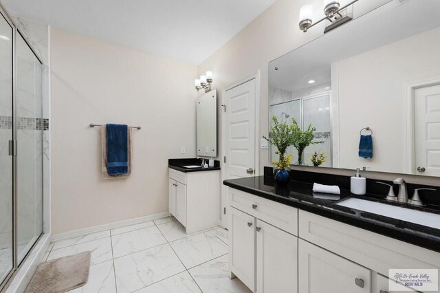 1903 W Webster Dr, Edinburg, TX 78542 - bathroom featuring a stall shower, marble look tile flooring, two vanities, and recessed lighting