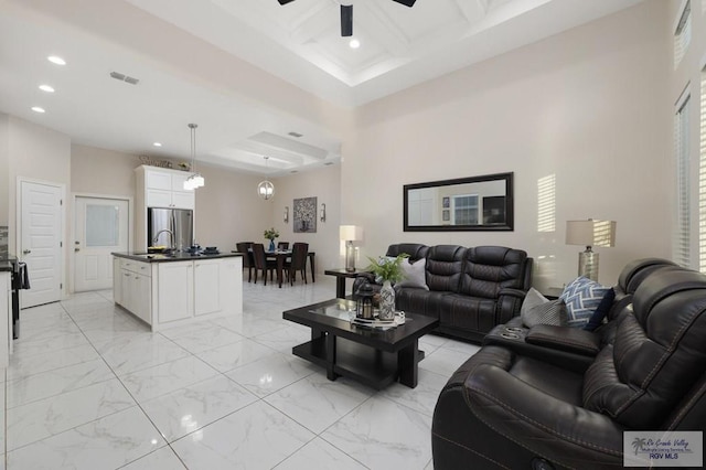 1903 W Webster Dr, Edinburg, TX 78542 - living room with recessed lighting, coffered ceiling, beamed ceiling, ceiling fan, and light marble finish floors