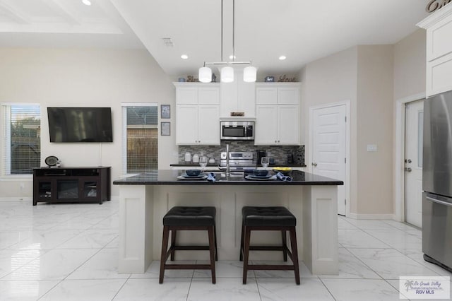 1903 W Webster Dr, Edinburg, TX 78542 - kitchen with stainless steel appliances, light marble finish floors, tasteful backsplash, white cabinets, and recessed lighting