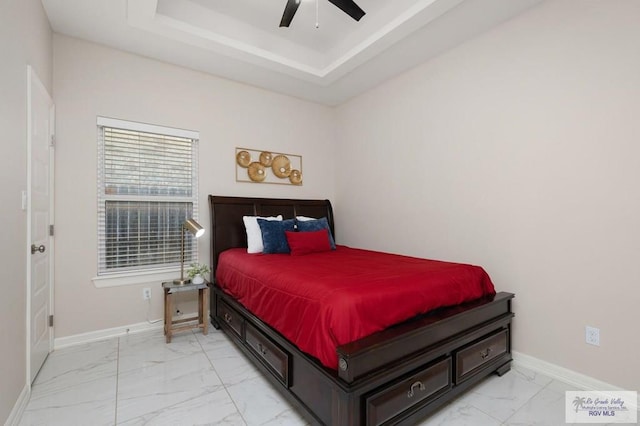 1903 W Webster Dr, Edinburg, TX 78542 - bedroom with light marble finish floors, a ceiling fan, and a tray ceiling