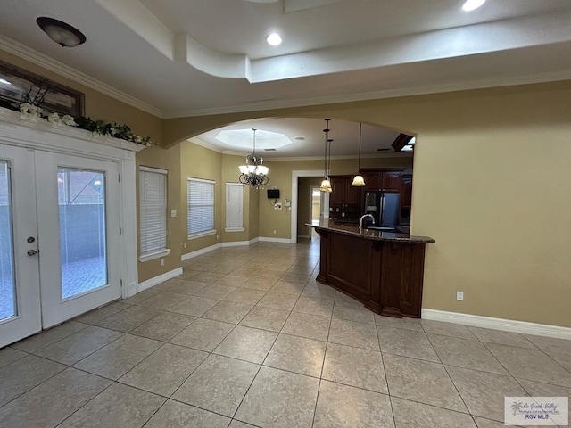 kitchen with french doors, decorative light fixtures, light tile patterned floors, black refrigerator, and ornamental molding