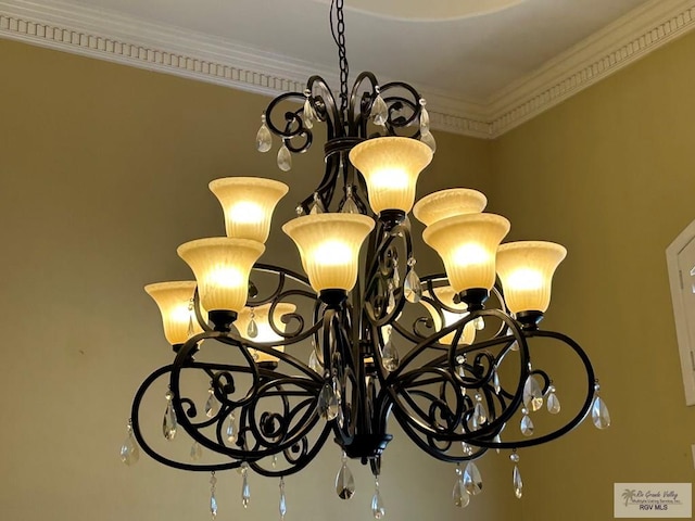 room details featuring ornamental molding and a notable chandelier