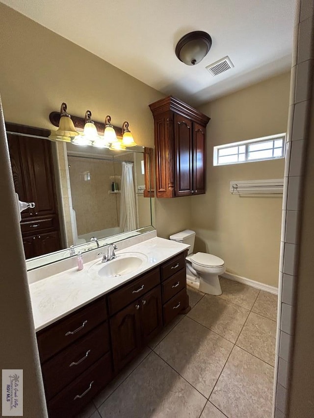 full bathroom with shower / tub combo, vanity, toilet, and tile patterned flooring