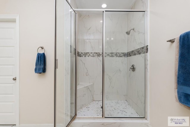 bathroom with a shower with door