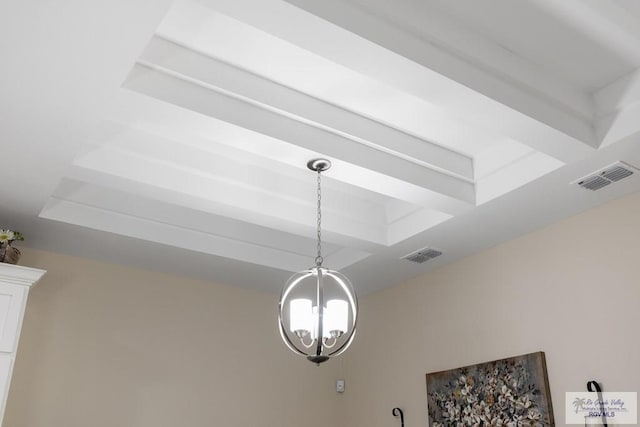 details with a tray ceiling and an inviting chandelier