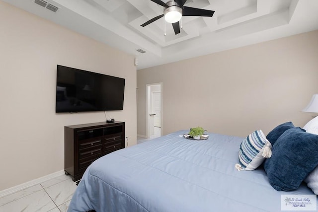 bedroom featuring ceiling fan and a raised ceiling