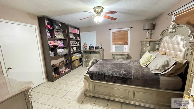 tiled bedroom featuring a textured ceiling, ceiling fan, and cooling unit