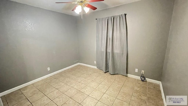 unfurnished room featuring ceiling fan and light tile patterned floors