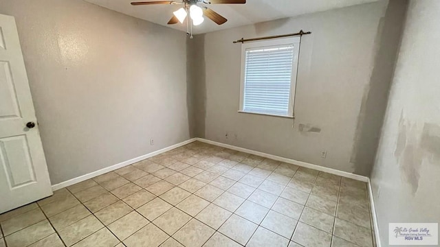 tiled empty room with ceiling fan