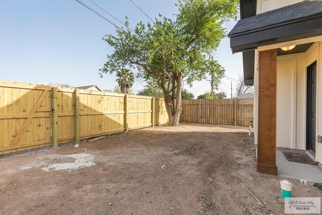 view of yard with a gate and a fenced backyard