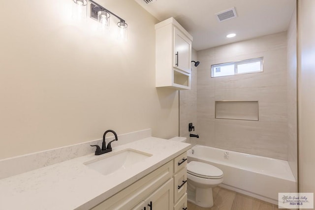 bathroom with shower / tub combination, visible vents, toilet, and vanity