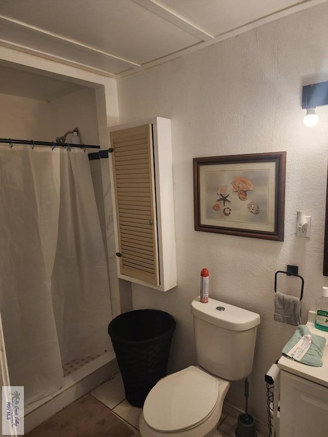 bathroom featuring toilet, tile patterned floors, and walk in shower