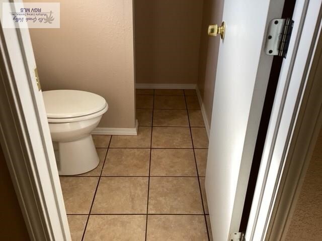 bathroom featuring toilet and tile patterned floors