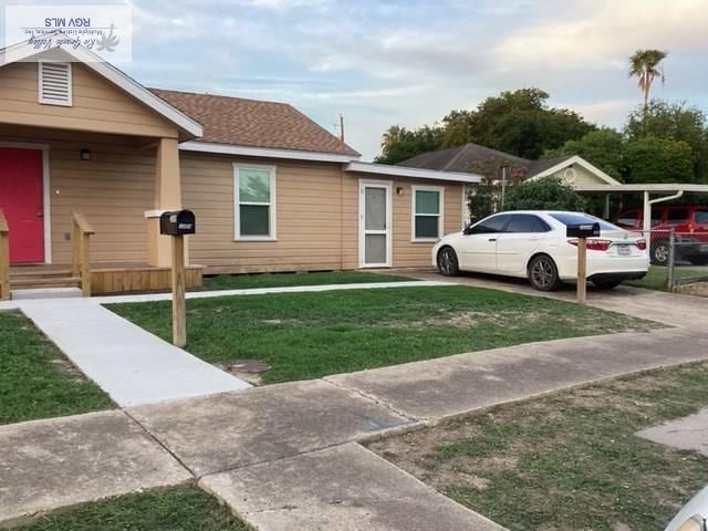 view of side of property with a lawn