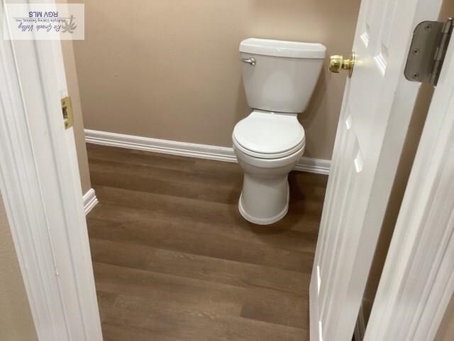 bathroom featuring hardwood / wood-style floors and toilet