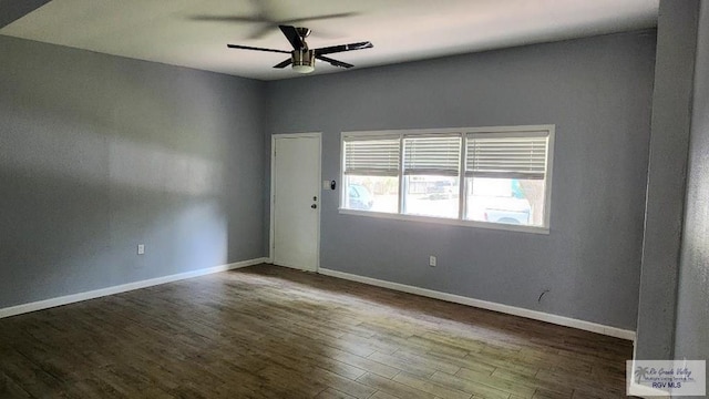 spare room with hardwood / wood-style floors and ceiling fan