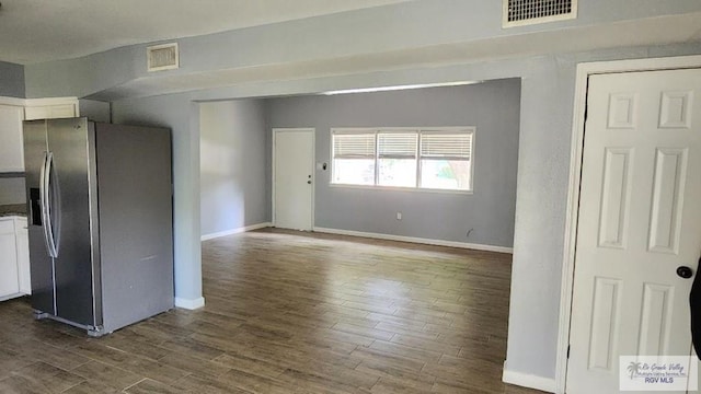 unfurnished living room with dark hardwood / wood-style flooring