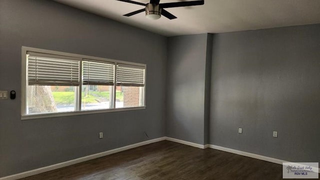 empty room with ceiling fan and dark wood-type flooring