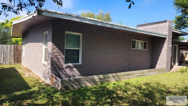 view of property exterior featuring a lawn