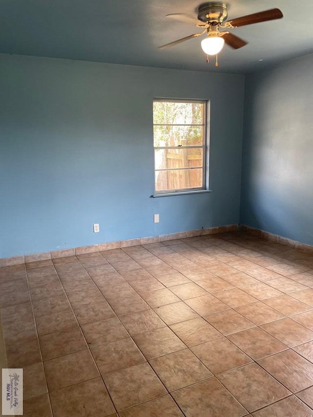 tiled empty room with ceiling fan