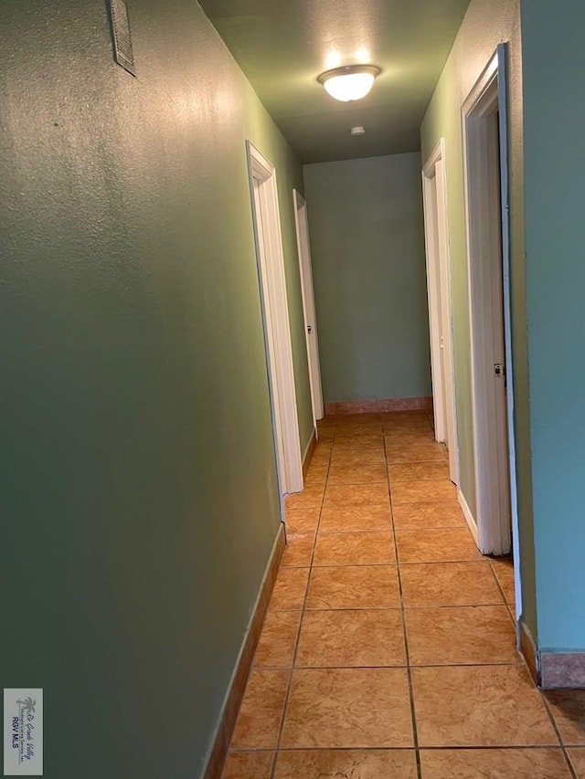 hall featuring light tile patterned flooring