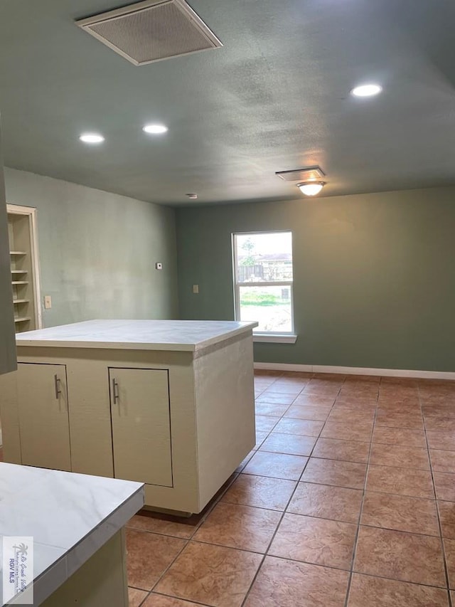 kitchen featuring a kitchen island and light tile patterned flooring