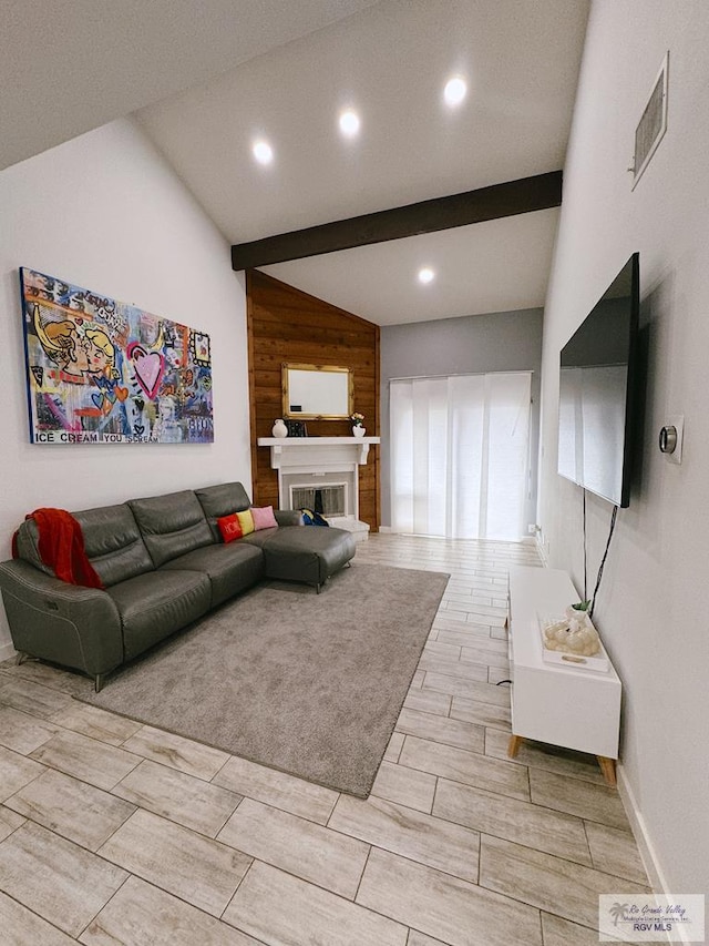 living room with lofted ceiling with beams