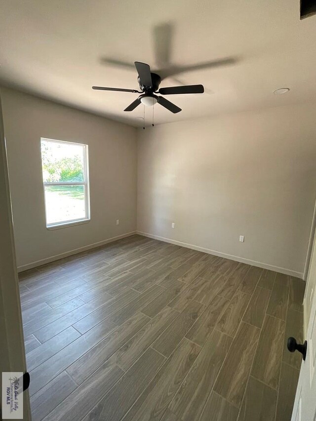 705 W Matz Ave, Harlingen, TX 78550 - empty room with dark wood finished floors and ceiling fan