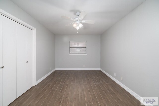 unfurnished bedroom featuring ceiling fan, a closet, and dark hardwood / wood-style floors