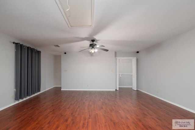 empty room with ceiling fan and dark hardwood / wood-style flooring