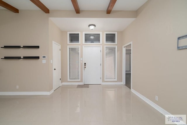 entryway featuring beamed ceiling and light tile patterned floors