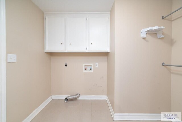 laundry area with hookup for an electric dryer, washer hookup, and cabinets