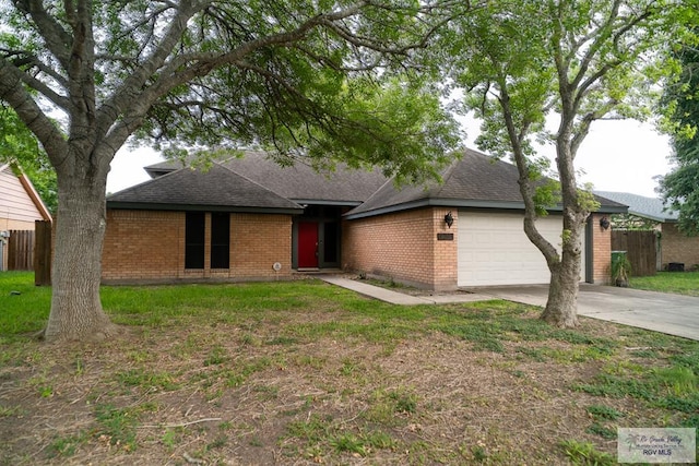 ranch-style house featuring a garage and a front lawn