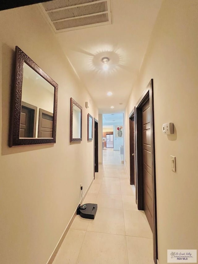 corridor with light tile patterned flooring