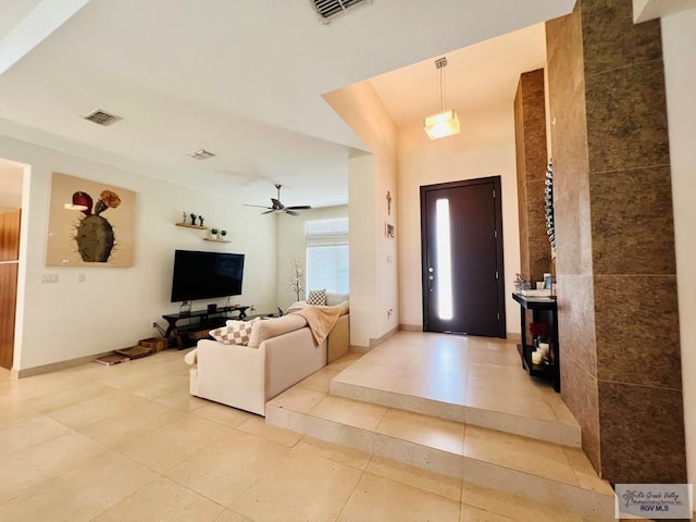 tiled foyer featuring ceiling fan