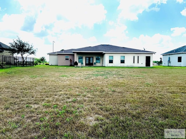 back of property featuring a yard